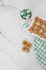 Top View of Tray with Chocolate Chip Cookies on a White Countertop with Christmas Decor; Three on a Plate in Front