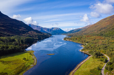 Fototapeta premium aerial view of loch linnhe in summer near duror and ballachulish and glencoe in the argyll region of the highlands of scotland showing blue water and green fertile coast line