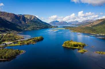 Naklejka na ściany i meble aerial view of loch linnhe in summer near duror and ballachulish and glencoe in the argyll region of the highlands of scotland showing blue water and green fertile coast line