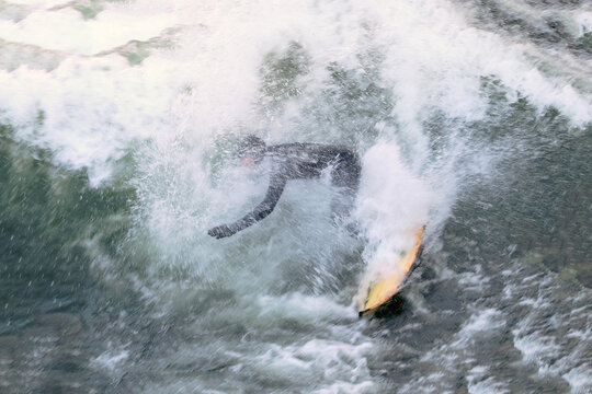 Surfer fighting a difficult wave