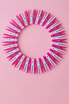 Pink and white clothespins form a circle