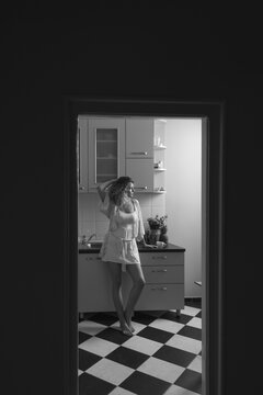 Woman in the Nightgown Standing in the Kitchen