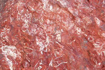 Red background, stone with veins. Natural stone surfaces, wallpaper and wallpaper.