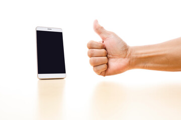 A smartphone and  a cropped hand with thumb up sign on white background 