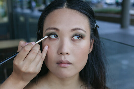 Make-up Artist Working with a Japanese Model in the Street