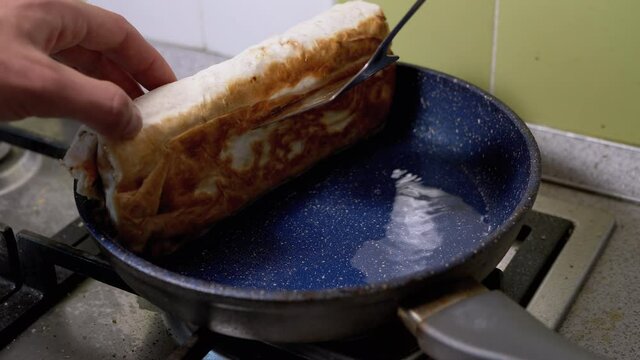 Cooking Meat Shawarma in a Hot Pan Until Crisp. Fry Pita Bread in Kitchen.