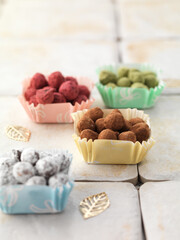 colorful hazelnut praline pave chocolate truffles in paper dish
