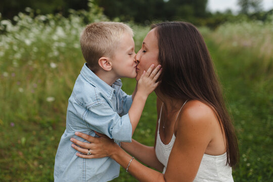 A sweet, candid kiss between a mother and her son