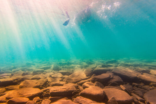 Underwater Photo of Kayak Passing Overhead WIth Rocky Bottom in Freshwater Lake at Family Cottage