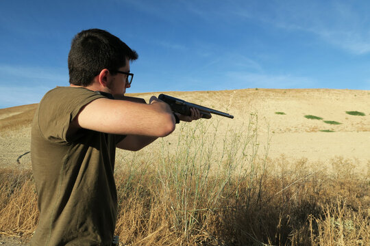 Young hunter aiming to the prey