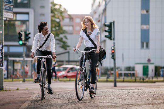 Two women using Bicycles to Commute