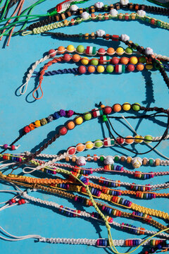 colorful summer bracelets on blue background