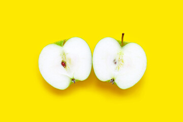 Fresh green apple on yellow background.