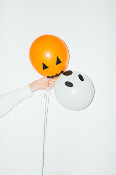 Woman Holding Halloween Party Balloons