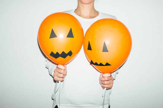 Woman Holding Halloween Party Balloons