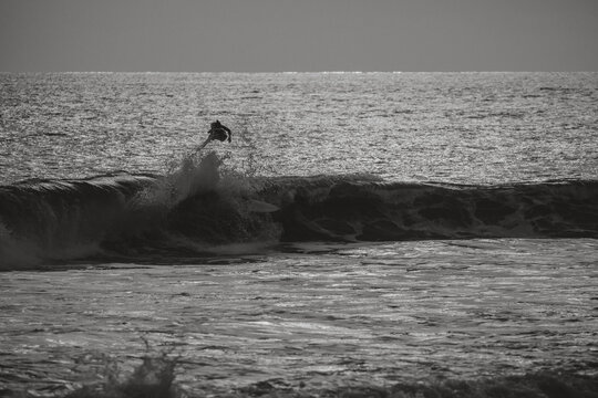 Surfer jumps from his board.
