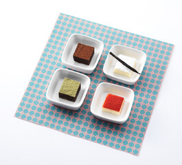 4 colorful chocolates in a cup on a napkin
