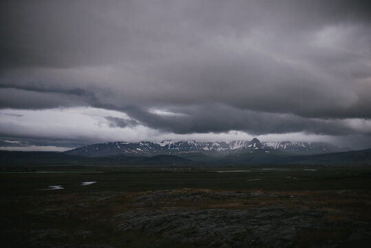 Dark and moody clouds over mountain landscape in Iceland
