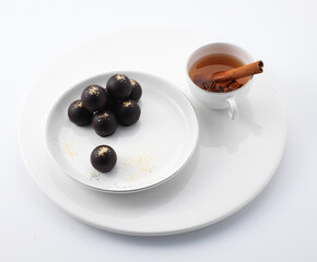 Wine-filled chocolate on a plate and vin chaud, mulled wine