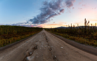Panoramic View of Scenic Road leading to Tombstone at Sunrise in Canadian Nature. Dempster Highway, Yukon, Canada.