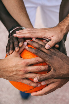 Four Multi-Ethnic Friends Stacking Hands