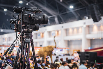 Video camera taking live video streaming with people working background at meeting room. Selective...