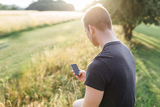 Runner Listening Music Playlist on the Mobile Phone