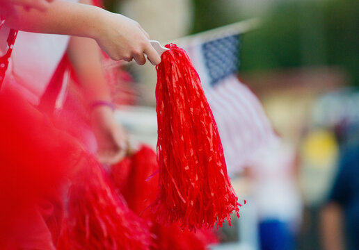 Hands of cheering crowd with pom poms