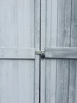 Detail of painted grey wood doors, close up