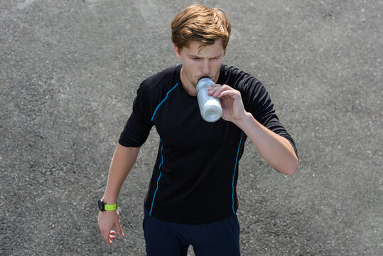 Man drinking water outdoors
