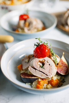 Roast pork tenderloin stuffed with figs and shallots served with sweet potato risotto.