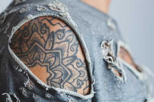 Shoulder Tattoo Closeup Through a Ripped T-Shirt