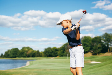 young golfer teeing off