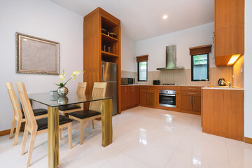 Interior design of house, home, villa and apartment feature dining table, chair, refrigerator, cabinet, hood microwave and oven in kitchen