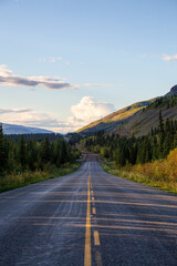 Scenic Road View of Klondike Hwy during a sunny and colorful sunset. Taken North of Whitehorse,...
