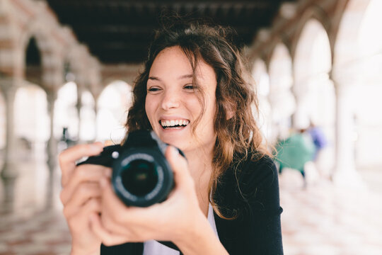 Pretty Young Female Photographer Taking Pictures in Italy