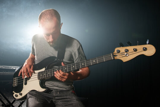 Guitar player in the spotlight on the stage