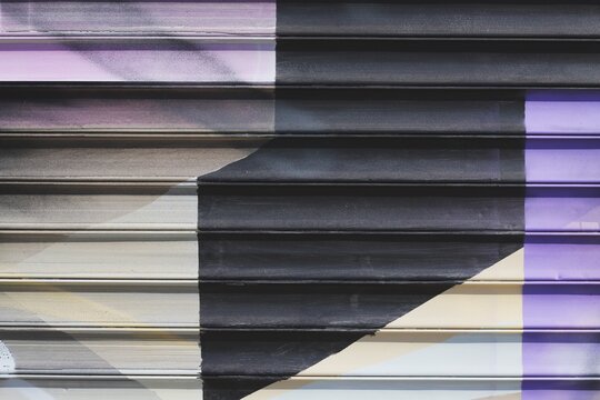 Textured metal wall background with colorful patterns and horizontal lines