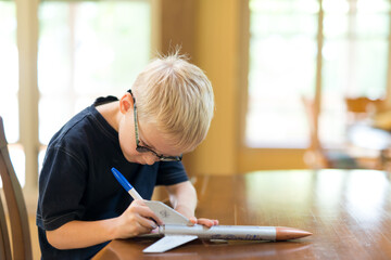 Creative Little Boy Rocket Scientist Drawing On Home Made Model Rocket Ready for Flight