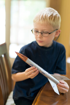 Creative Little Boy Rocket Scientist Holding Home Made Model Rocket Ready for Flight