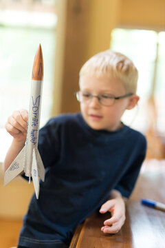 Creative Little Boy Rocket Scientist Showing Home Made Model Rocket Ready for Flight