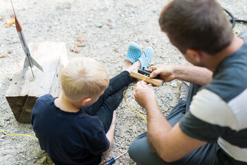 Creative Father and Son Rocket Scientist Building Home Made Model Rocket Launch Pad