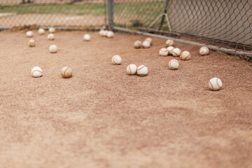 baseballs behind home plate during batting practice