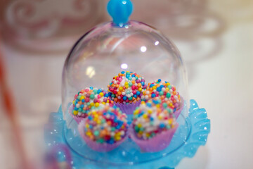 Table with children's birthday party decoration with objects and colorful candies