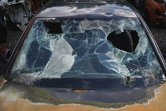 Rusty carwreck with broken windshield