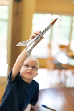 Creative Little Boy Rocket Scientist Imagining WIth Home Made Model Rocket Ready for Flight