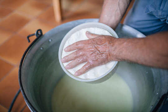 Senior man making homemade cheese