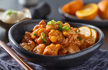 bowl of chinese orange chicken on table top