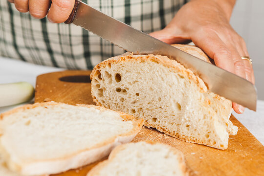 Senior Woman Cutting Stale Bread for the Tuscan Tomato Bread Soup, Pappa al Pomodoro