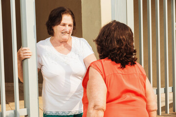 ladies shaking hands in front of the house